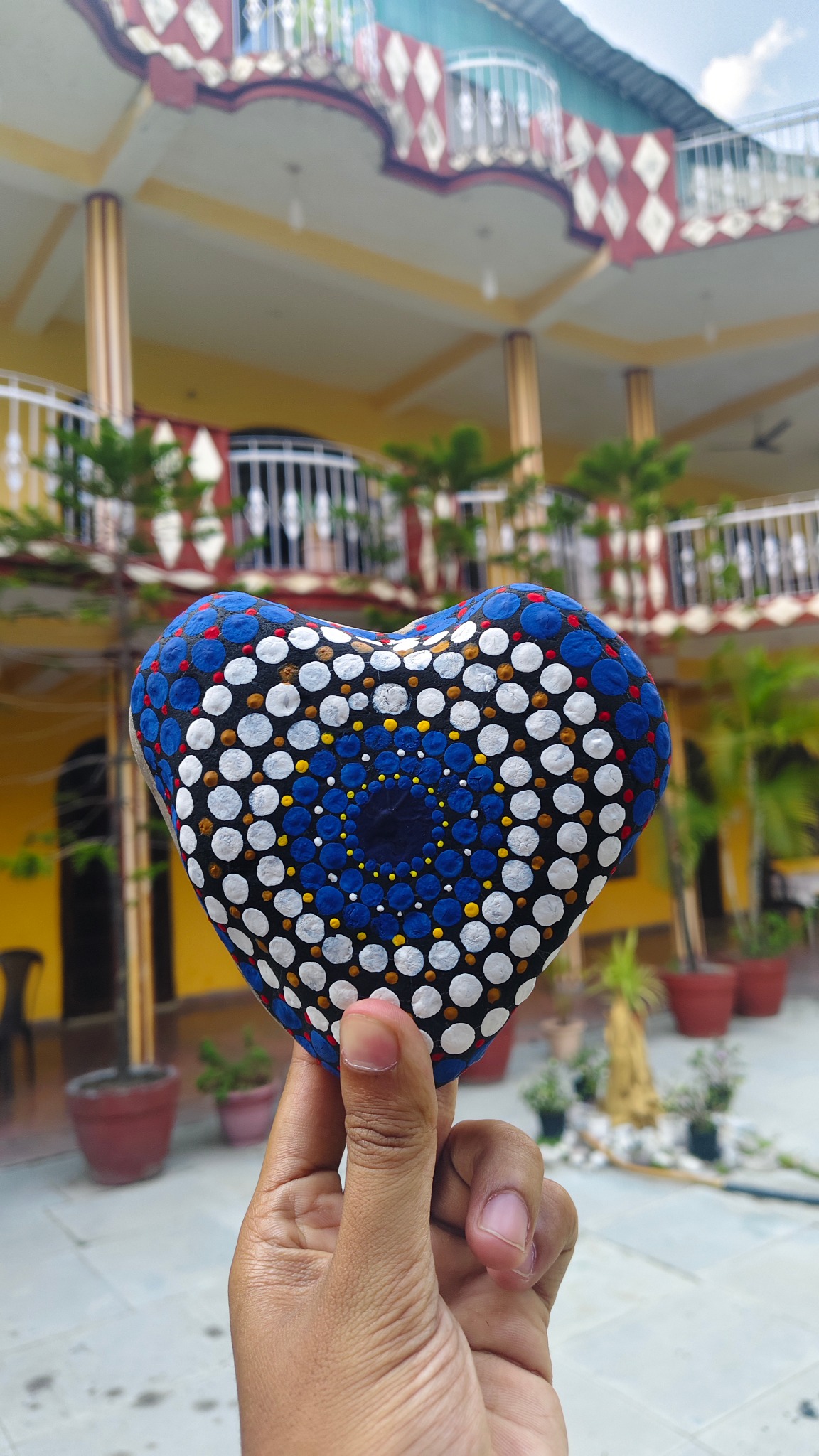 Hand-painted blue stone heart at Samvedna Spiritual School